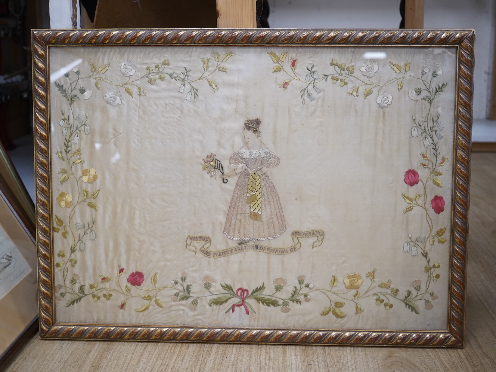 A mid 20th century, appliqué on silk 19th century lady walking in a classical garden by lake (possibly Italy), together with a silk embroidery “virtue and plenty are the off spring of temperance”, appliqué 38.5cm x 57cm.